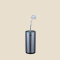 NovaPulse AutoMist car humidifier in dark grey with a gentle mist and USB power