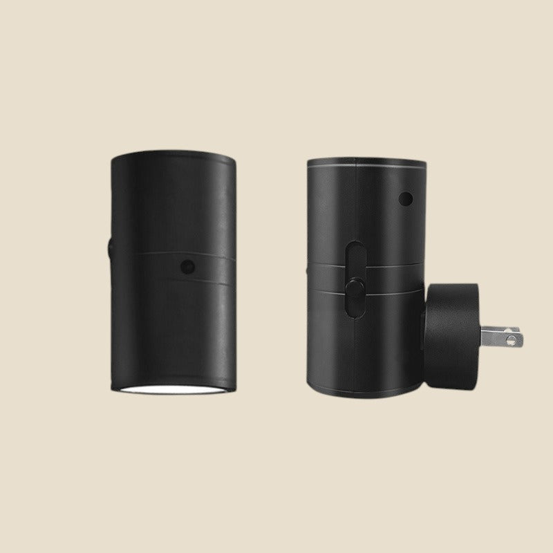 Two black NovaPulse plug-in LED spotlights with adjustable warm beams on a light background