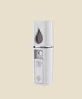 NovaPulse NanoMist portable facial mist sprayer in white with a decorative heart-shaped button