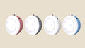 Four round NovaPulse motion-sensor night lights in pink, grey, white and blue