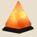 NovaPulse pyramid-shaped Himalayan salt crystal lamp emitting warm amber light