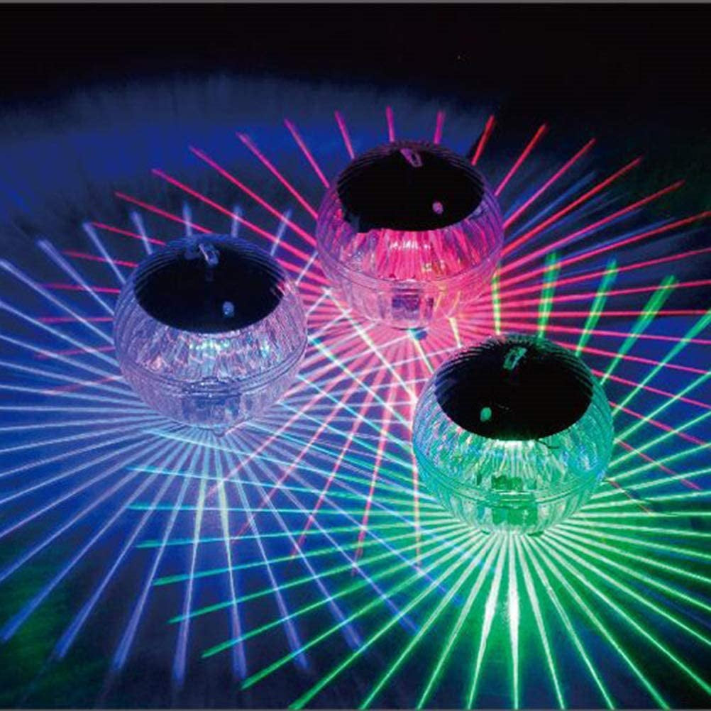Three NovaPulse floating solar globes casting coloured light in a garden pond